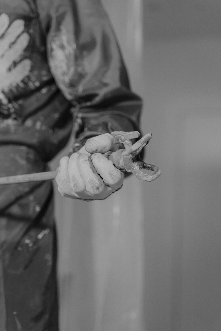 Person Holding Gray Metal Tool
